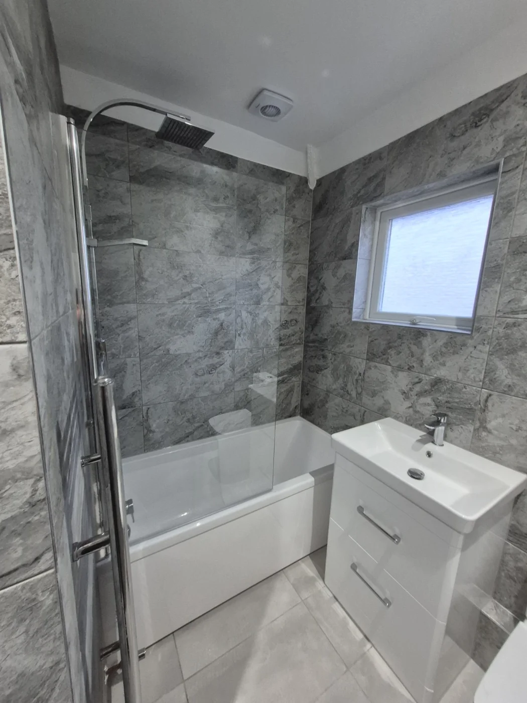 Over-bath shower, glass screen and white vanity unit — Queenborough bathroom renovation