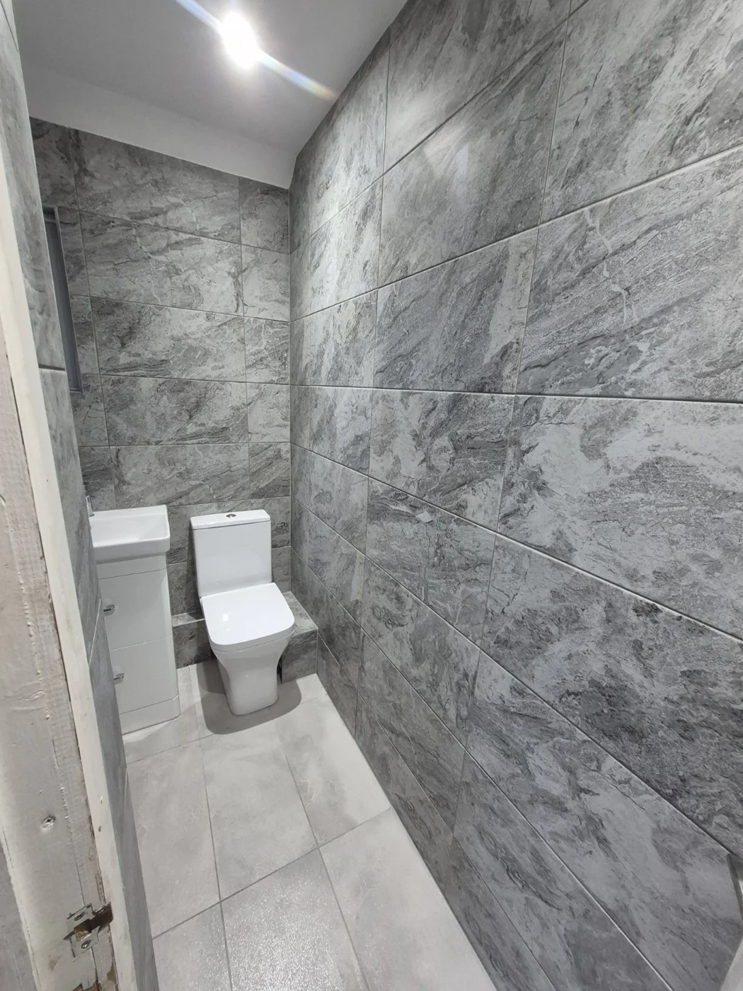 Grey wall finishes and light flooring viewed from the doorway — Queenborough bathroom renovation